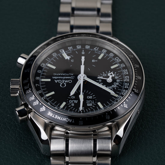 Omega Speedmaster Day-Date 3520.50 - frontaal aanzicht ondersteboven met kroon en drukknoppen zichtbaar aan de linkerzijde